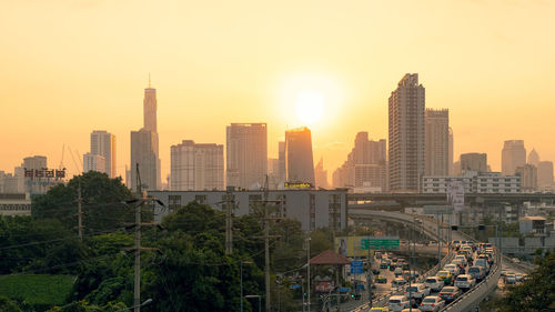 View of buildings in city at sunset