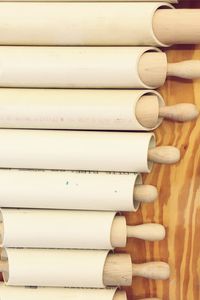 High angle view of rolling pins on table
