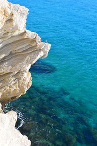 High angle view of rock formation in sea