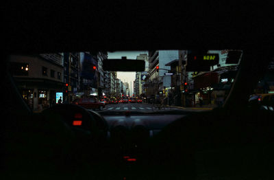 Close-up of cars against sky seen through car windshield