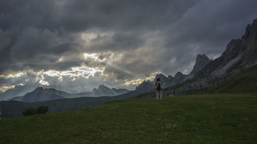 Man standing on mountain against sky