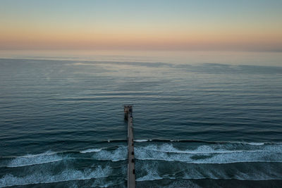 Aerial view of scripps pier looking out on the ocean, horizon. space for text.