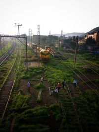 High angle view of people working on field against sky