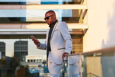 African american businessman with mobile phone on a summer afternoon.