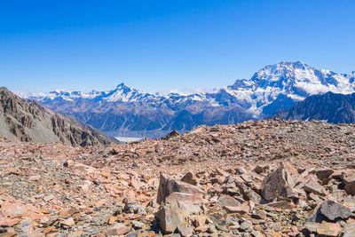 Scenic view of snowcapped mountains against blue sky