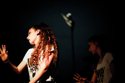 Close-up of girls dancing at night