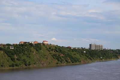 Scenic view of sea and buildings against sky