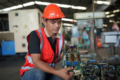 Portrait of male worker standing in the heavy industry manufacturing factory.