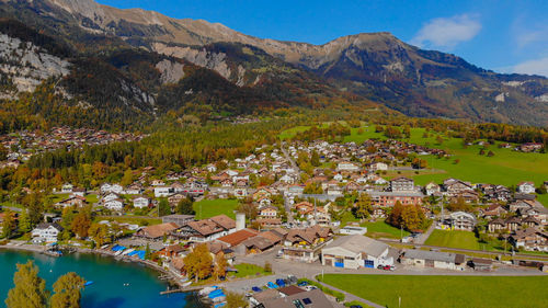 High angle view of townscape by mountains against sky