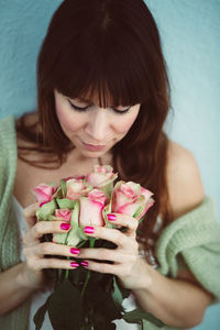 Close-up of woman smelling roses