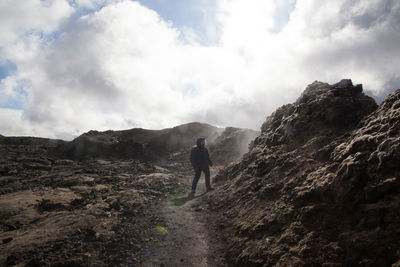 Geologist exploring rocky landscape