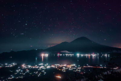 High angle view of city lit up at night