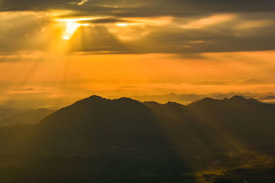 Scenic view of silhouette mountains against sky during sunset