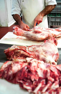 Close-up of person preparing food on cutting board