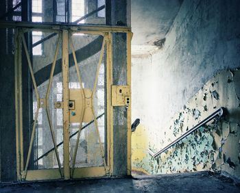 Abandoned building seen through broken window