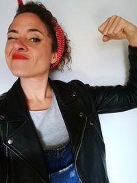 Portrait of woman flexing muscles at home