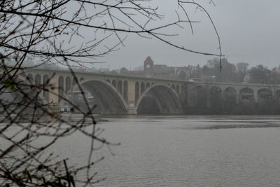 Bridge over river with city in background