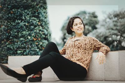 Full length of woman sitting on seat