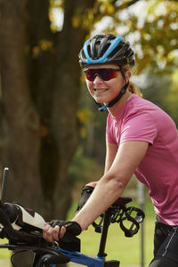 Smiling female cyclist looking at camera