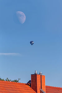 Low angle view of buildings against clear blue sky