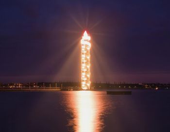 Illuminated building against sky at night