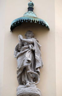 Low angle view of statue against wall