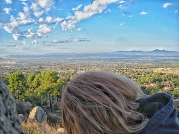 Rear view of woman on landscape against sky