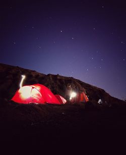 Illuminated tent against clear sky at night