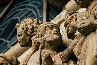 Close-up of old statue against temple