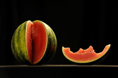 Close-up of apple on table against black background