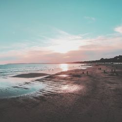 Scenic view of beach against sky during sunset