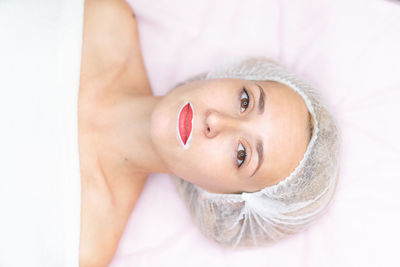 Portrait of woman lying down on bed at spa