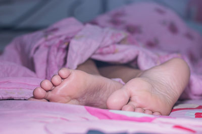 Close-up of baby lying on bed