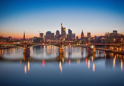 Illuminated cityscape against sky at night