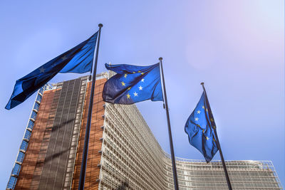 Low angle view of flags against building