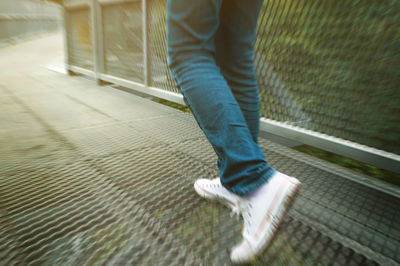 Low section of man standing on footpath