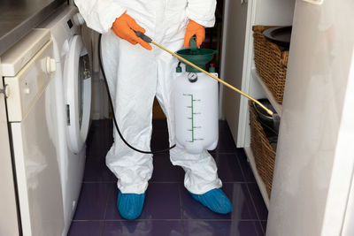 Low section of man working in bathroom