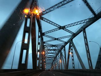 Low angle view of bridge against sky at night