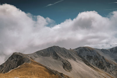 Scenic view of mountains against cloudy sky