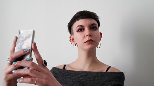 Portrait of young woman using mobile phone