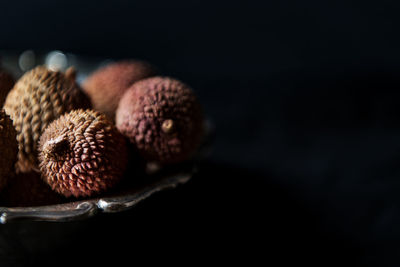 Close-up of fruits over black background