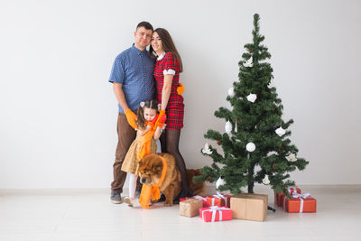 Couple standing in front of christmas tree