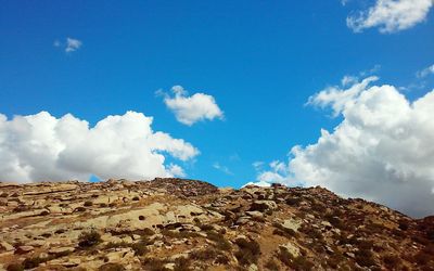 Low angle view of mountain against blue sky