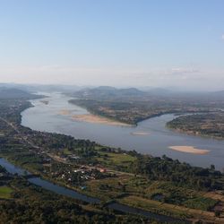 High angle view of river and cityscape against sky