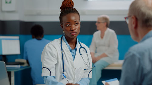 Doctor talking with patient in clinic