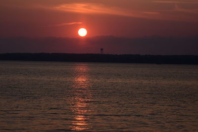 Scenic view of sea against romantic sky at sunset