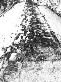 Reflection of snow on puddle on road