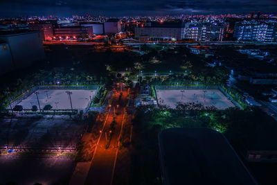 High angle view of illuminated buildings in city at night