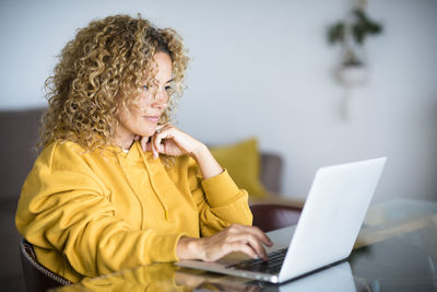 Woman using laptop at home