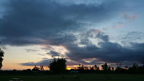 Scenic view of field against cloudy sky